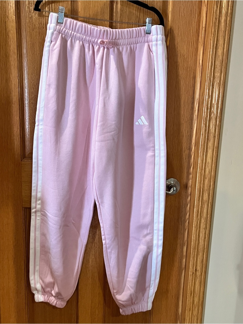 Adidas' Pink Track Pants with White Stripes